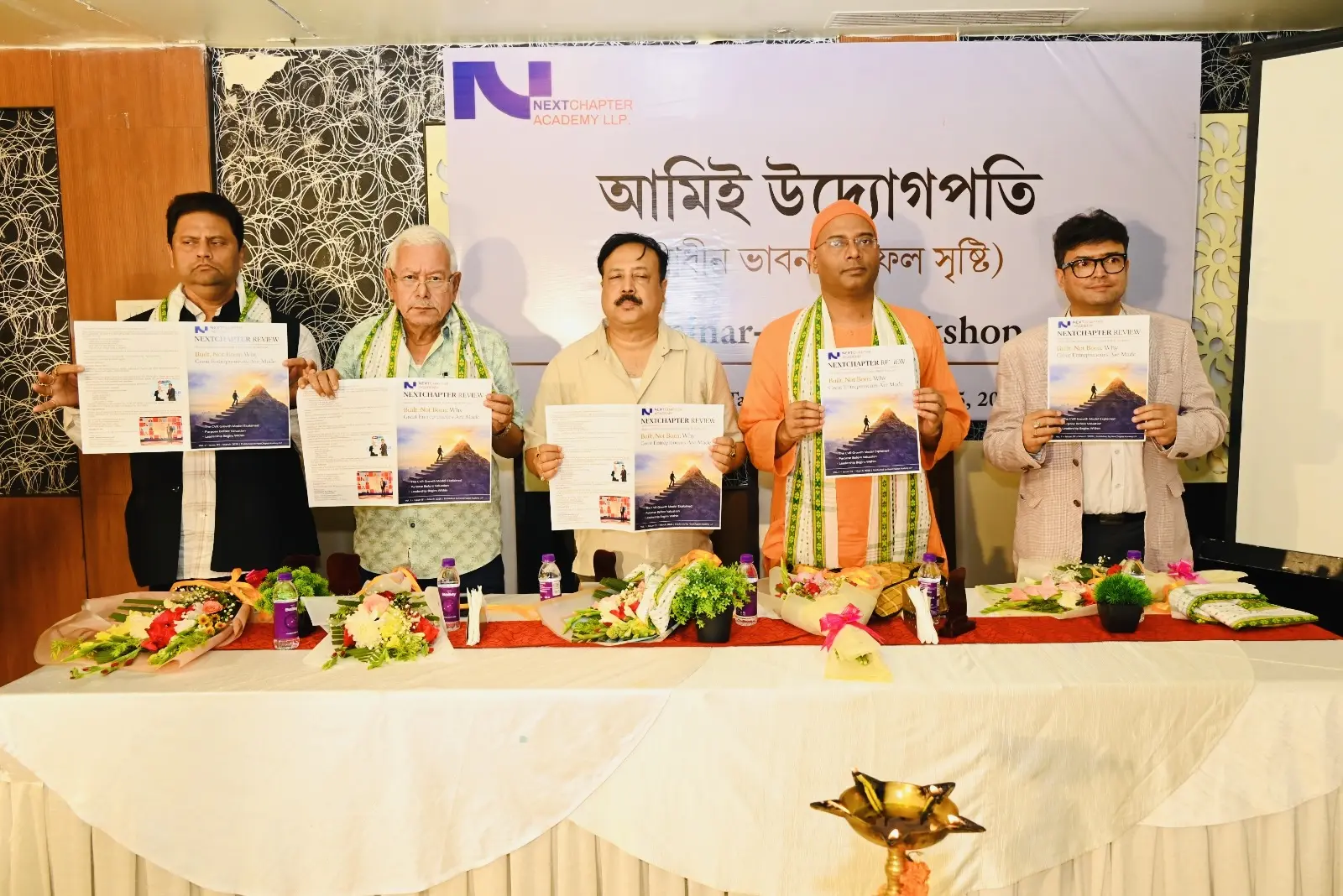Dignitaries unveiling the printed NextChapter Review journal on stage at the Ami Udyogpati seminar-cum-workshop